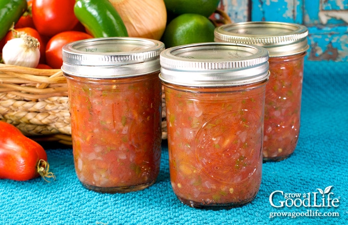 harvest basket and jars of salsa on a table