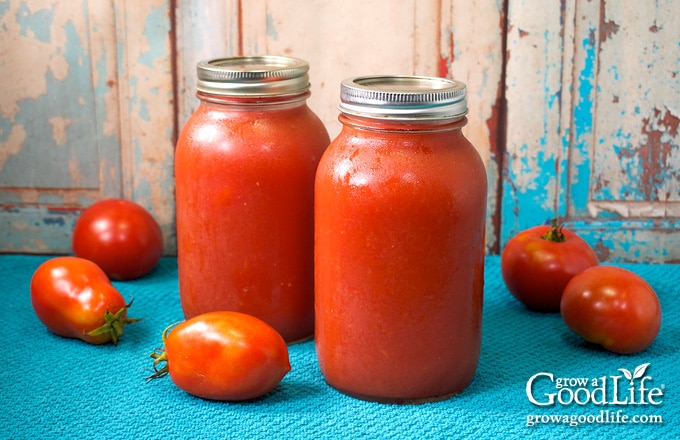 quart jars of tomato puree on a table