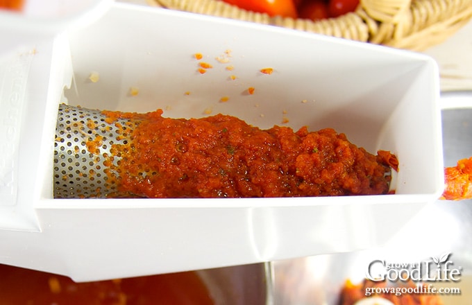 using a food strainer to strain tomatoes