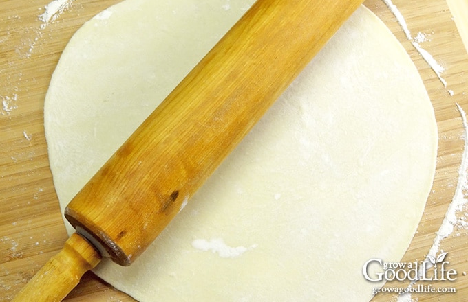 rolling out the tortilla with a rolling pin