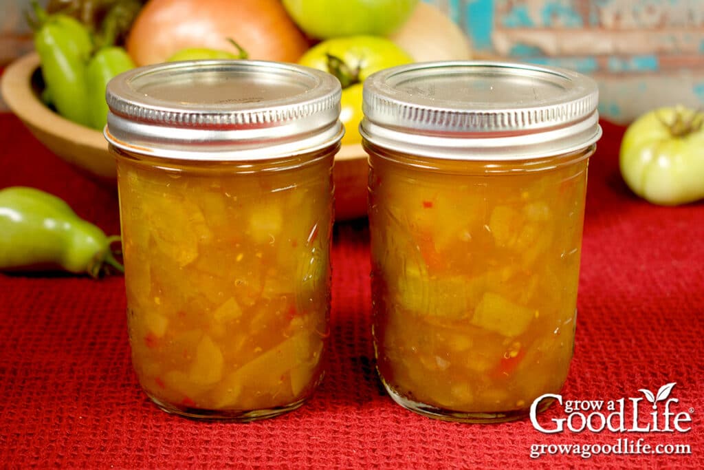 Jars of home canned piccalilli on a table.