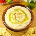 This simple recipe for white bean dip is filled with flavor. Begin with Cannellini beans, add roasted garlic, rosemary, olive oil, and brighten with lemon juice and zest. Puree to a smooth and creamy texture that pairs well with crackers and veggies.