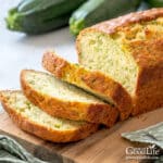 Sliced zucchini bread on a cutting board.