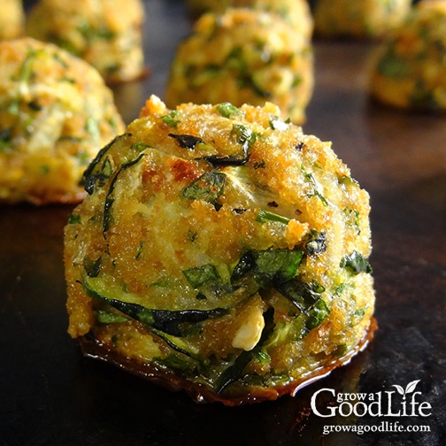 close up image of a zucchini ball on a baking sheet